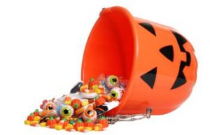 Upturned helloween bucket with spilled candies