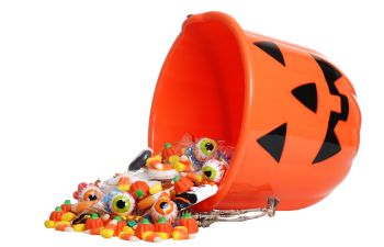 Upturned helloween bucket with spilled candies