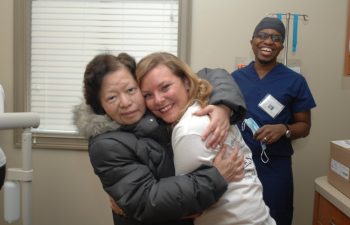 Dr. Damarius, one of the “Free Dental Day” team and a happy patient