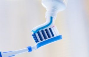 Toothpaste is applied to the toothbrush